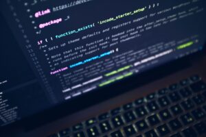 A laptop screen displays code in a dark-themed text editor, highlighting the skills acquired through SAP Online Certification.